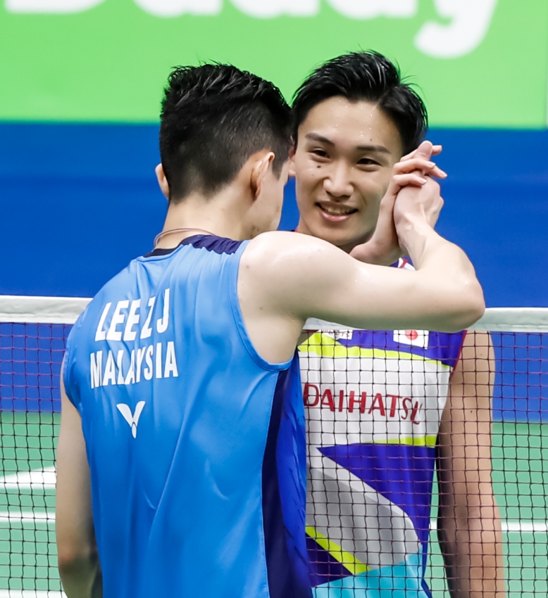 Malaysia’s Lee Zii Jia congratulates Kento Momota of Japan