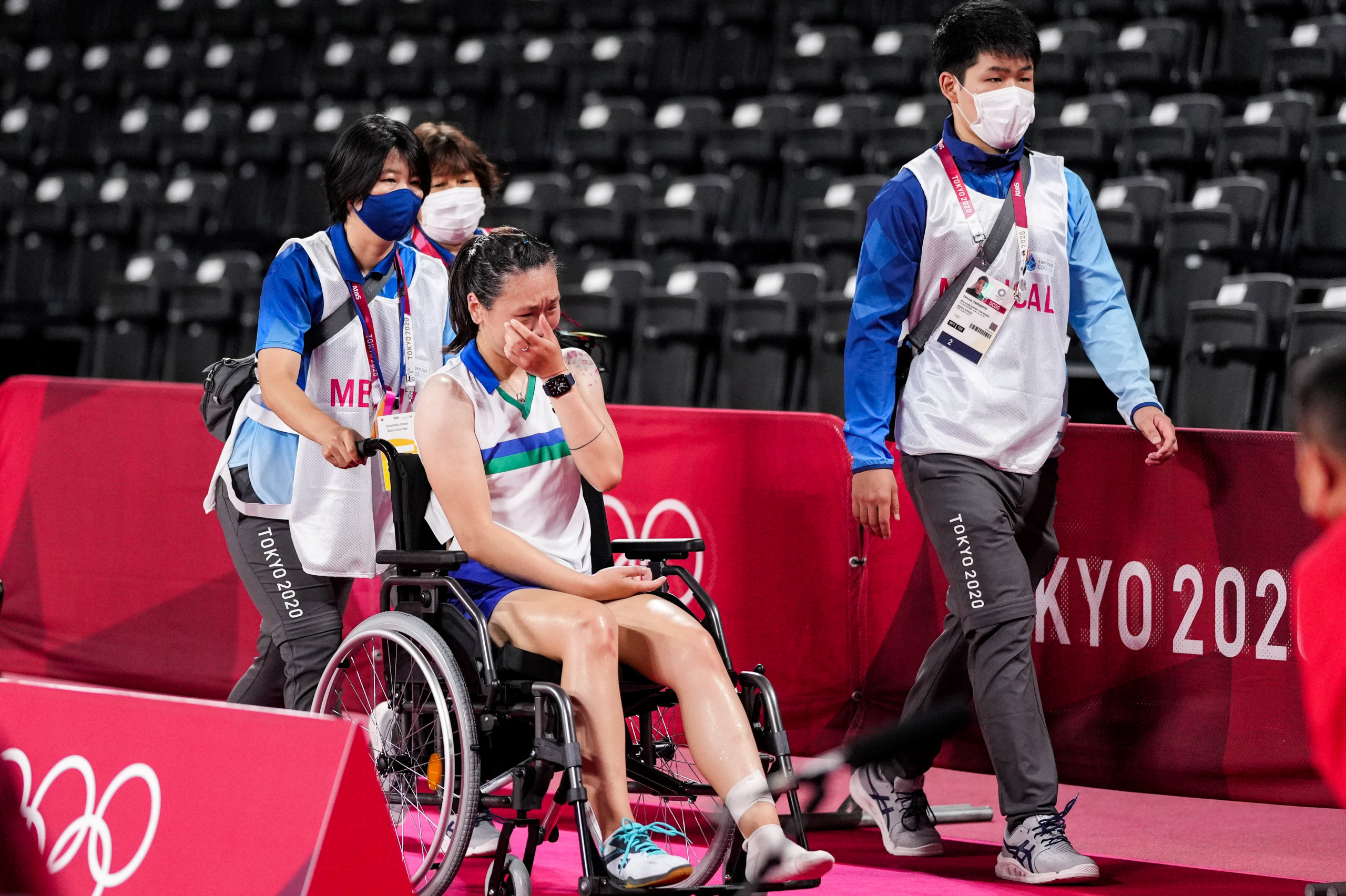 Zhang Beiwen being wheeled off following her injury at Tokyo 2020.